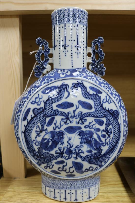 A Chinese blue and white moon flask decorated with dragons